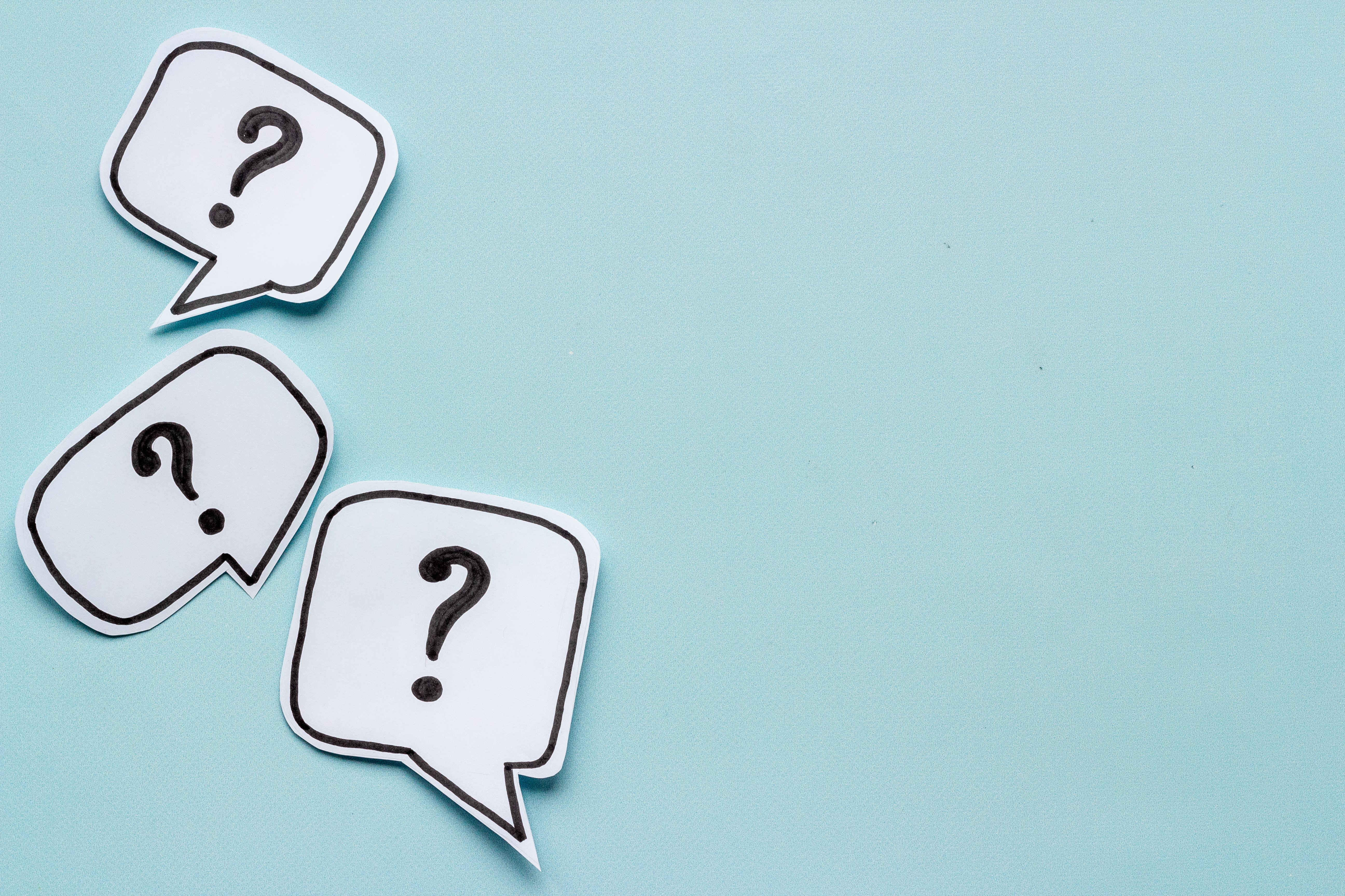 Blue background image with three speech bubbles with a question mark on the inside