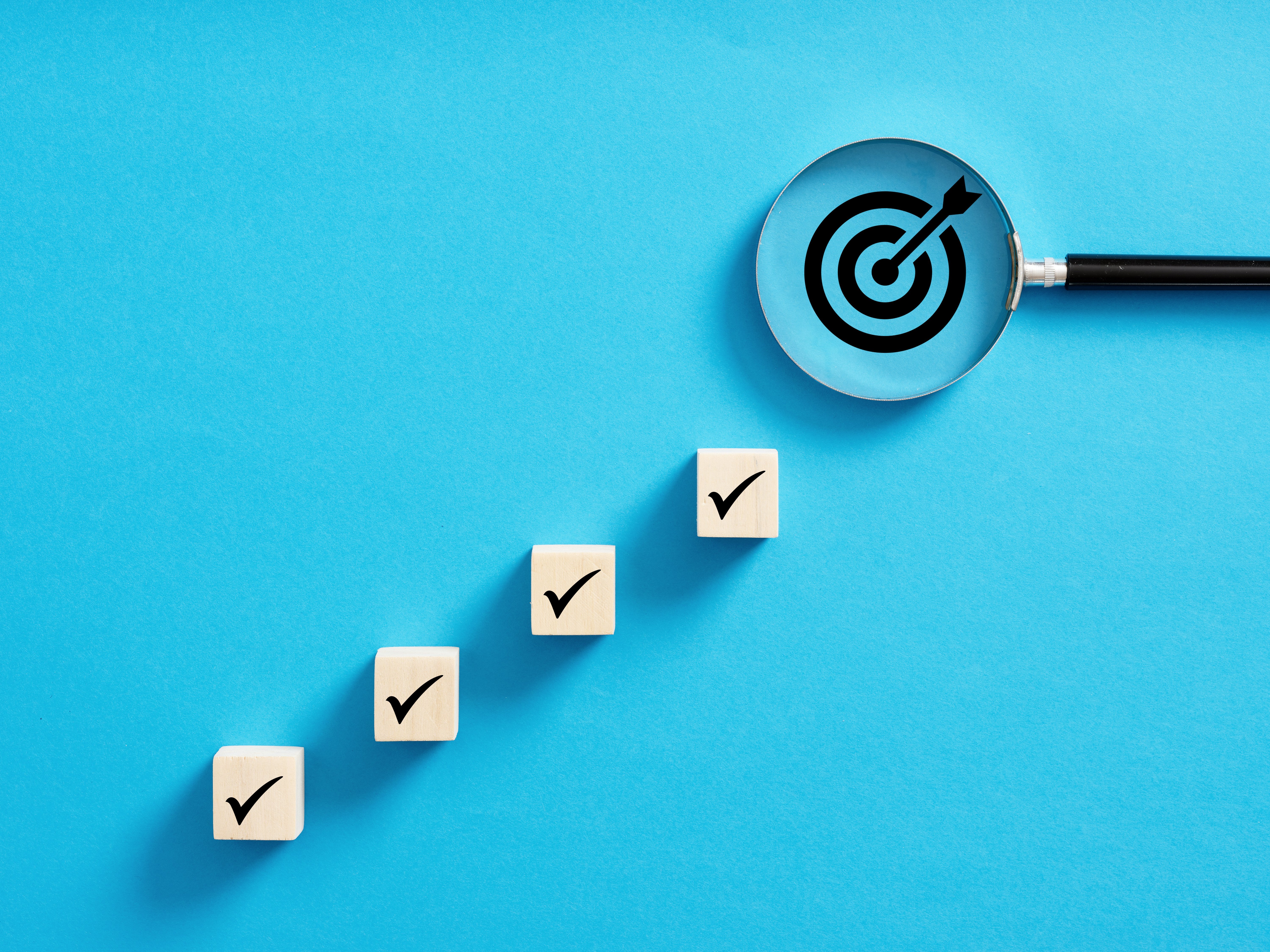 Image of 4 tickets ascending to the right with a magnifying glass over an arrow in a target in the top right corner.